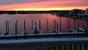 A marina at dusk with calm water reflecting the sky.