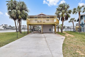 Situated on a quiet driveway, this two-story residence offers a balcony overlooking a tranquil body of water.