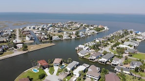 A residential area with houses along a waterway, featuring docks and a marina.