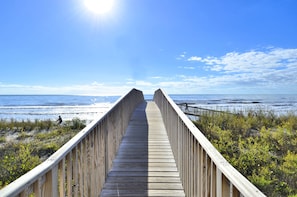 Walk along the beachside boardwalk surrounded by lush vegetation and enjoy the ocean views.
