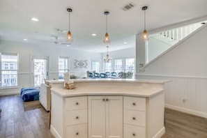 Enjoy cooking in this well-equipped kitchen with a central island, sink, and ample counter space.
