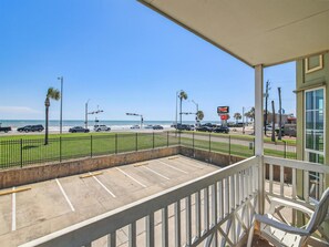 Enjoy the serene ocean views from this beachfront balcony with a clear view of the parking area.