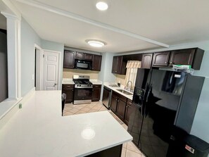 Microwave, dishwasher, coffee/tea maker, cookware/dishes/utensils