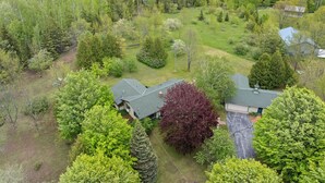 A residential area with multiple houses surrounded by dense greenery and trees. - 5 Acres in Ellison Bay! The Goddess Door Family Home (Ellison Bay)
