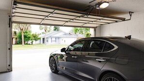 A garage with a car parked inside.