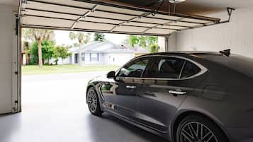 A garage with a car parked inside.
