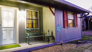 A house with a front door, a bench, and a decorative star.