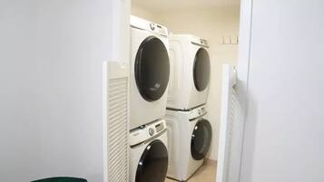 A laundry room with two stacked front-loading washing machines.