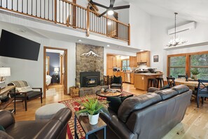 Smart TV, fireplace, books, computer monitors