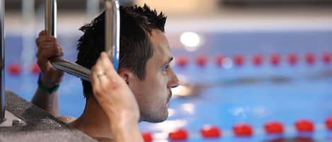 A person in a swimming pool with lane dividers.