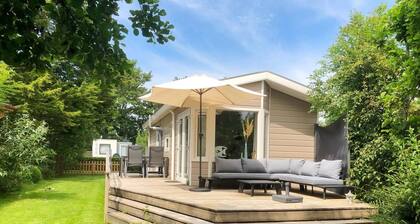 Surrounded by greenery and trees you will find this lovely four-person chalet. After a visit to the beach, you can enjoy all the luxury and comfort of your holiday chalet.