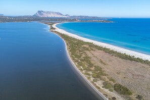 An aerial view of a coastal area with a beach, clear blue waters, and a mountain in the background. - "Elegante appartamento centro" with 2 Terraces & Wi-Fi (san teodoro)