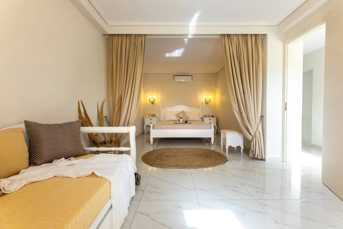 A modern bedroom with a bed, bedside tables, and a nightstand.