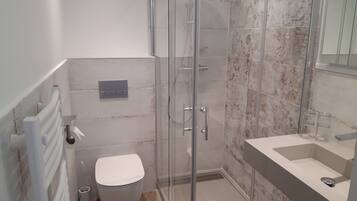 Shower, rainfall showerhead, hair dryer, towels