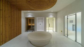 A modern interior with a central circular seating area, a wooden slatted wall, and glass doors leading to other rooms.