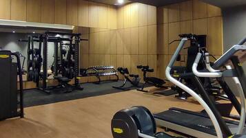 A gym with exercise equipment, including treadmills and weight machines.