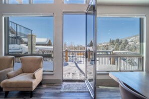 Relax on the balcony with a clear view of the serene snow-covered landscape.