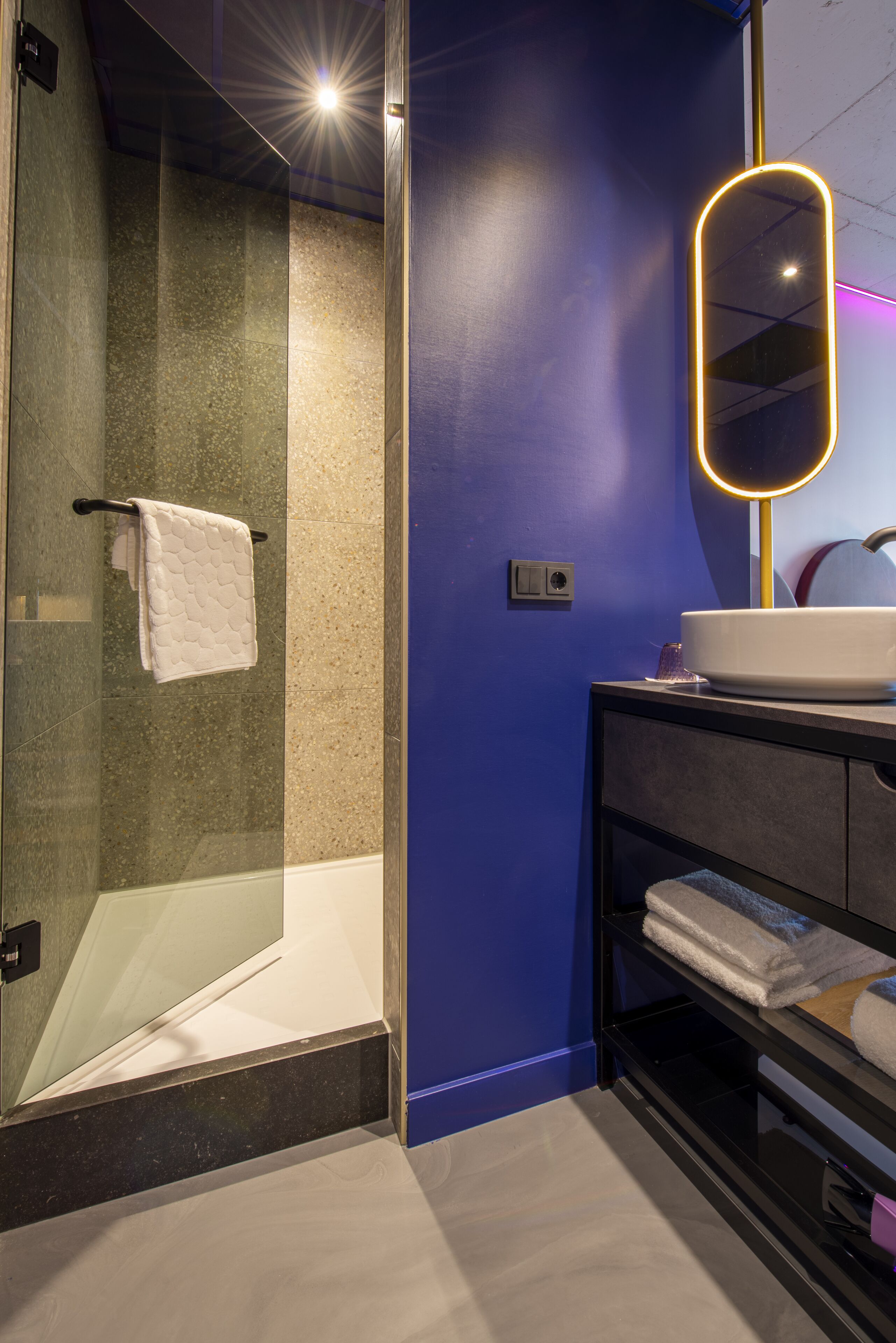 deluxe room | bathroom | shower, rainfall showerhead, hair dryer, towels