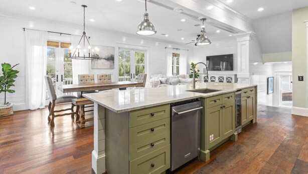 A spacious kitchen with a large island, built-in appliances, and a dining area with a view.