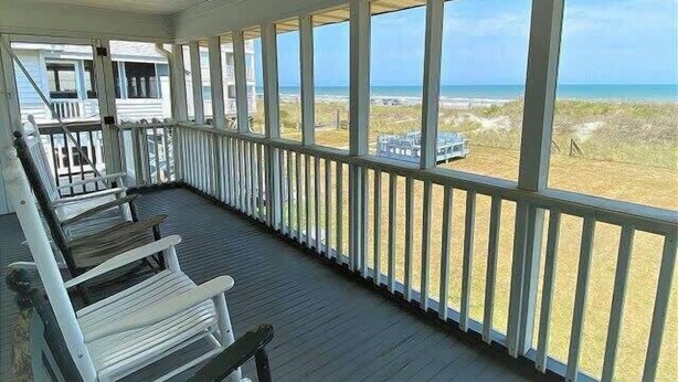 A covered porch with a view of the beach. - Cool Air Cottage- Upstairs- Ocean Front Duplex (North Myrtle Beach)