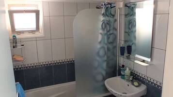 Tina con regadera, secadora de cabello, toallas