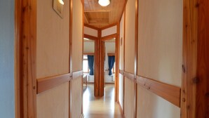 A wooden hallway with a high ceiling and a central light fixture. - Holiday home in Butgenbach near the Lake (Bütgenbach)