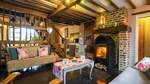 A cozy living room with a fireplace, wooden beams, and a staircase. - Scenic Retreat in Gimnée (Gimnée)