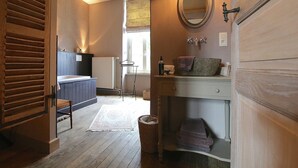 A bathroom with a wooden vanity, a mirror, a towel rack, and a radiator. - Rustic Charm, Modern Comfort (Latour)