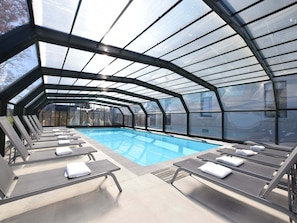 A heated pool, pool loungers