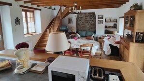 A kitchen with a microwave, toaster, and coffee maker on the counter.