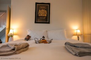 Relax in comfort with a neatly made bed, a convenient coffee station, and a charming view of the staircase.