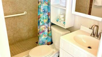 Shower, hair dryer, towels, shampoo