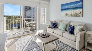 A balcony with a view of a building and a beach.