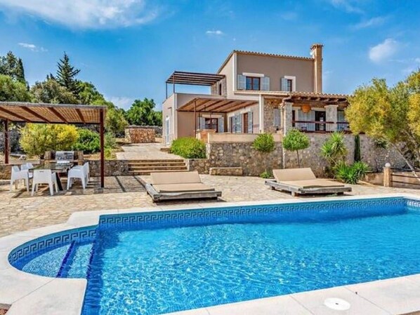 Relax by the pool surrounded by a spacious deck and pergola.