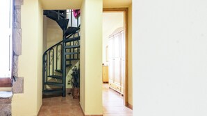A staircase with a metal railing leading to a landing.