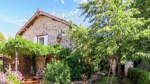 A stone house with a garden.