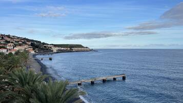 Beach nearby, black sand, sun loungers, beach umbrellas