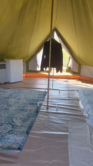 A tent interior with a standing heater, a rug, and a hanging item. - VILLA WITH PRIVATE POOL (Zagreb)