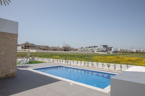 A swimming pool with a clear view of the surrounding residential area. - Villa Belle, Brand New Luxury 3BDR Protaras Villa with Private Pool (Protaras)