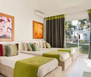 A hotel room with two beds, a large window with curtains, and artwork on the walls. - One Resort Aqua Park & Spa (Monastir)