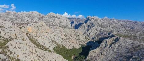 A mountainous landscape with rocky terrain and sparse vegetation.