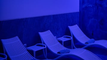 Relax in a serene space with lounge chairs and a unique mural.