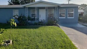 A single-story house with a front porch, a small front yard, and a driveway. -   5min drive to Universal studio (Orlando)