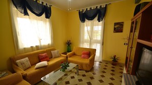 A living room with two sofas, a coffee table, and a television.