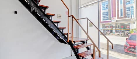 A staircase with wooden steps and metal railings inside a building.