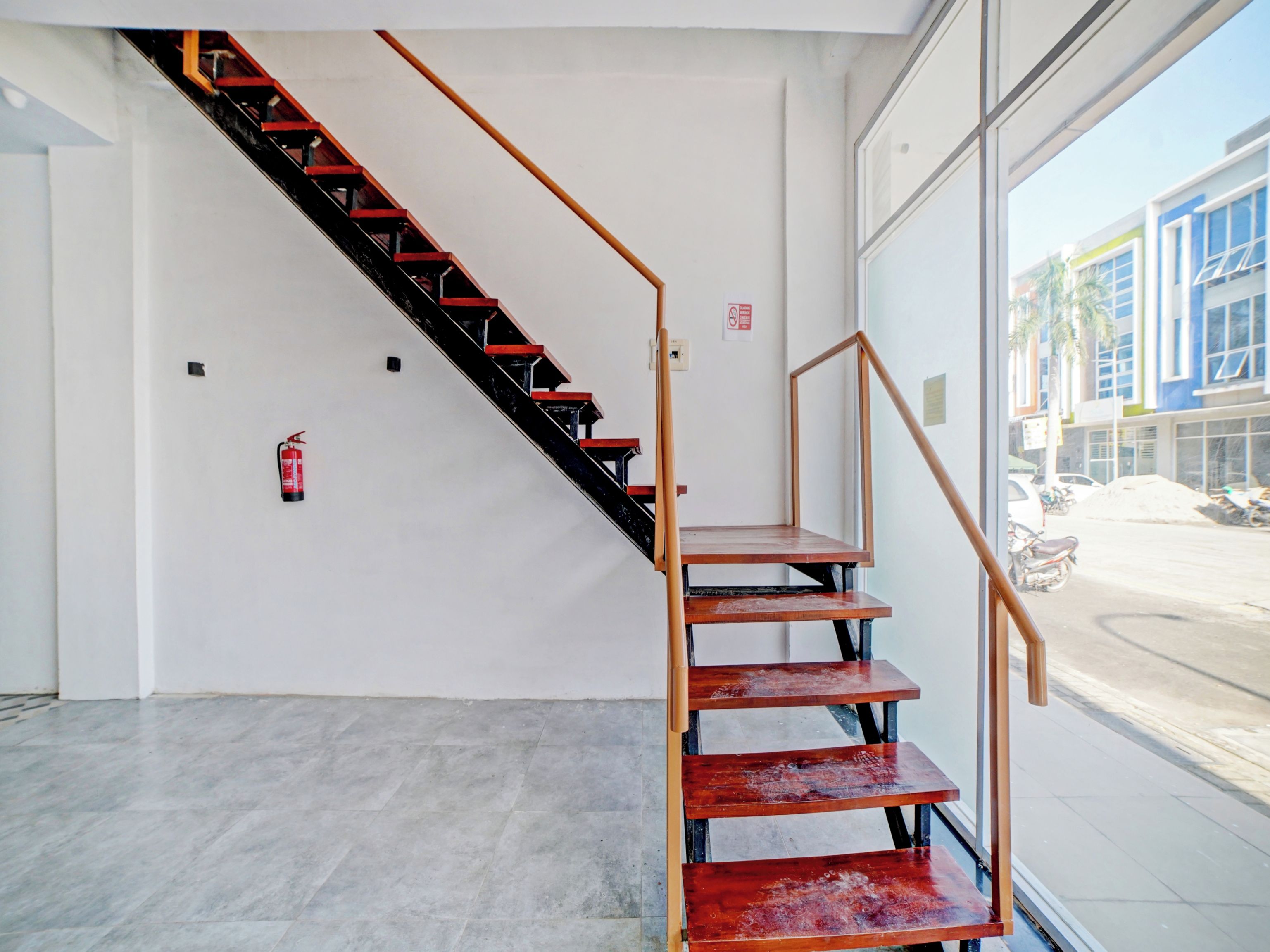 A staircase with a metal railing and wooden steps leading to an upper floor.