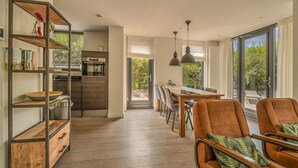 A modern kitchen with wooden cabinetry and a dining area with a large table and chairs.