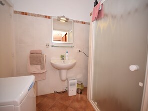 A bathroom with a sink, mirror, towel rack, and shower area. - Holiday Home Mesa del Mar near Black Beach (Tacoronte)