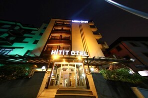 The exterior of a hotel with a prominent 'HITIT HOTEL' sign, a glass entrance, and a staircase leading to the lobby. - Hitit Otel (Ankara)