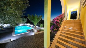 A pool area with a staircase leading to a covered upper level. - Holiday Home in Policnik with Private Pool (Policnik)
